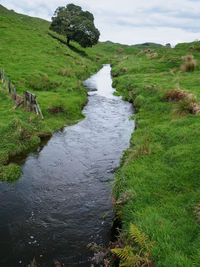 Scenic view of waterfall against sky