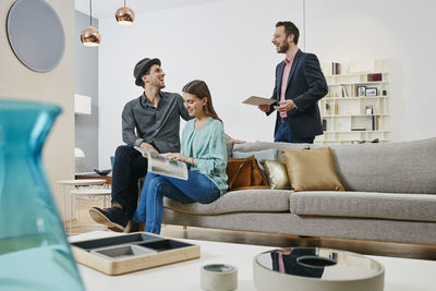 Couple talking to salesman in furniture store