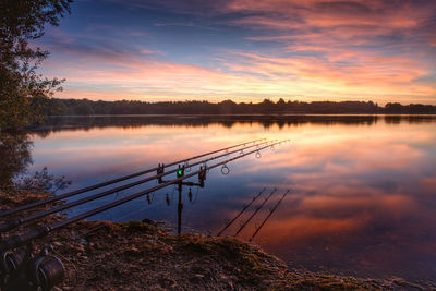 Scenic view of lake against sky during sunset