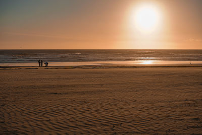 Scenic view of beach against sky during sunset