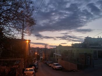 Buildings against cloudy sky at sunset