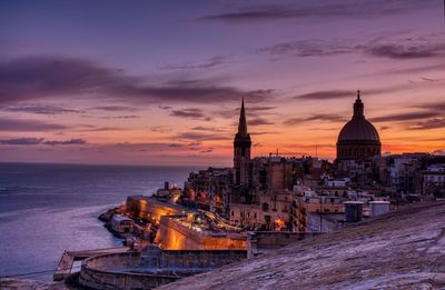 Panoramic view of buildings against sky during sunset