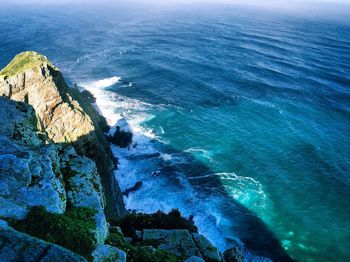 High angle view of sea by cliff