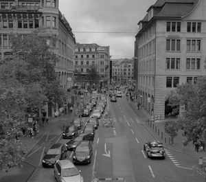 Vehicles on road along buildings