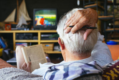 Close-up of man sitting in kitchen