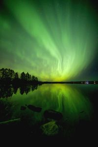 Scenic view of lake against sky at night