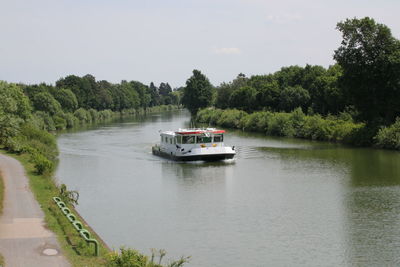 Boat sailing in river against sky