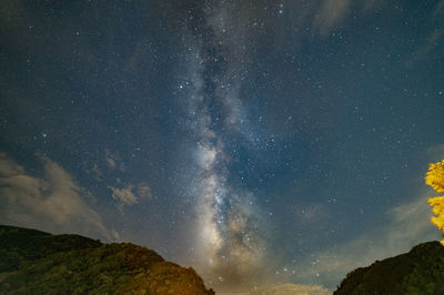 Low angle view of mountain against sky at night