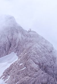 Scenic view of snow covered mountain against sky