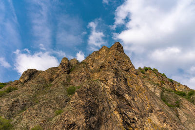 Low angle view of rock formation against sky