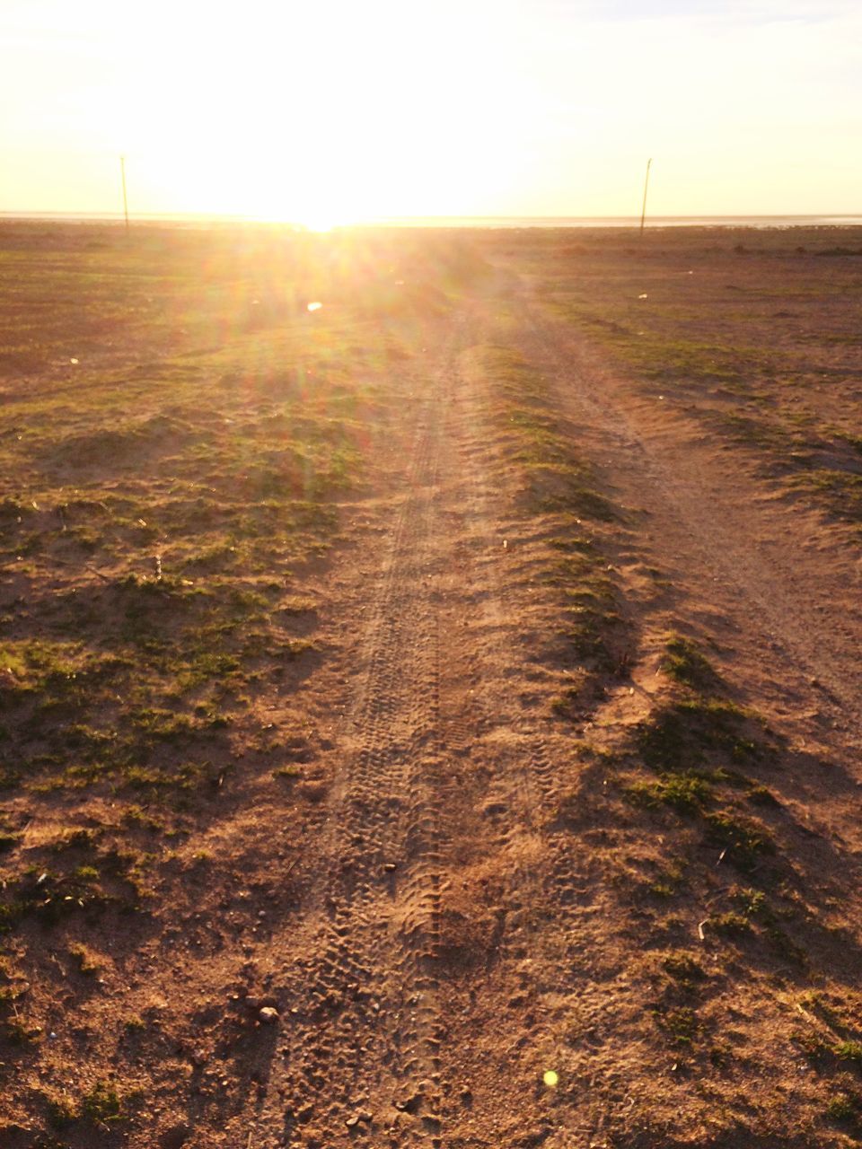 sunset, sky, landscape, sunlight, tire track, outdoors, sunbeam, nature, beauty in nature, no people, scenics, day