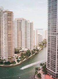 Cityscape by sea against sky