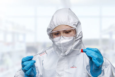 Portrait of female scientist holding dentures