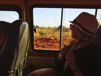 Side view of woman sitting in car 