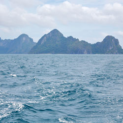 Scenic view of sea and mountains against sky