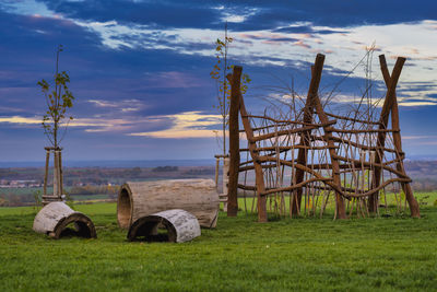 Hay bales on field against sky
