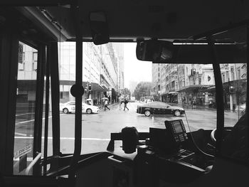 Cars on road seen through bus windshield