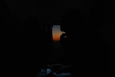 Portrait of silhouette man holding car