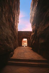 Archway of historical building against cloudy sky