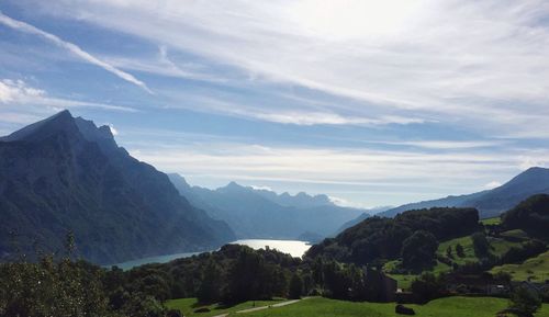 Scenic view of mountains against cloudy sky