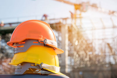 Close-up of yellow hardhat against construction site