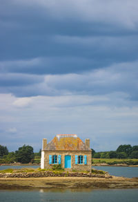 Building by sea against sky