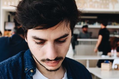 Close-up of young man looking down