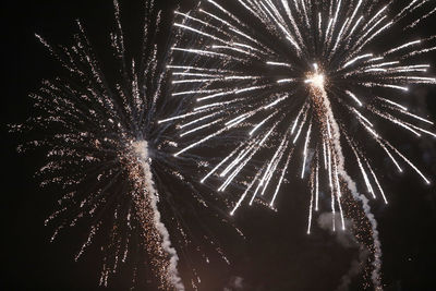 Low angle view of firework display at night