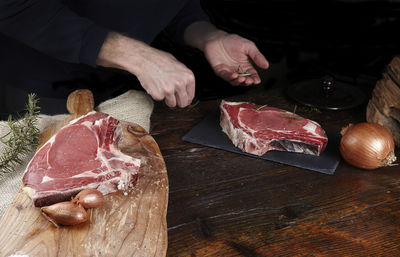 Close-up of man preparing food on cutting board