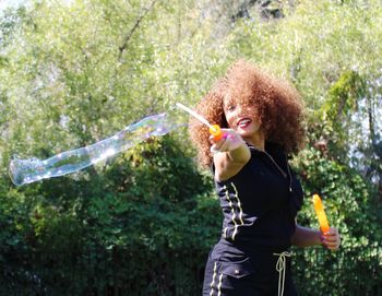 Young woman blowing bubbles