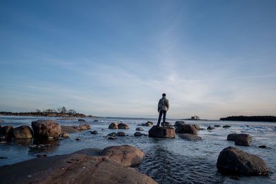 Woman on beach against sky