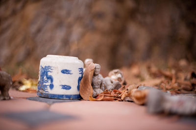 Figurines by cup in cemetery