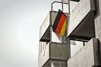 Close-up of german flag hanging on railing