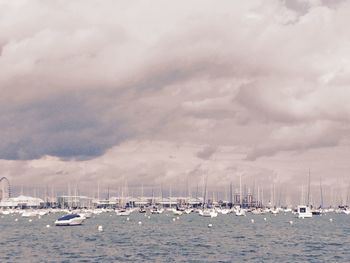 Sailboats in sea against sky