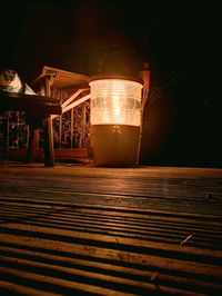 Illuminated electric lamp on table