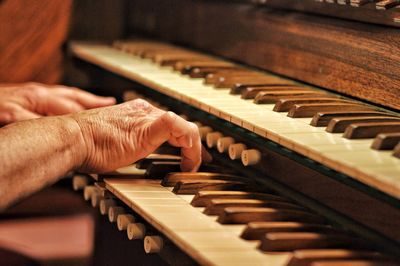 Cropped hands playing piano