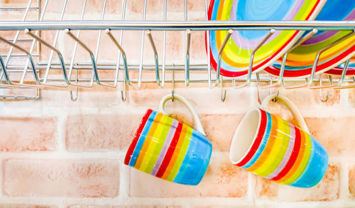 Close-up of colorful crockery in rack