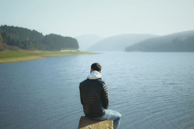 Rear view of woman looking at lake