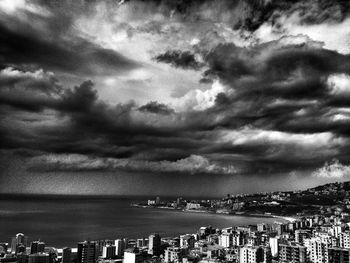 View of cityscape against cloudy sky