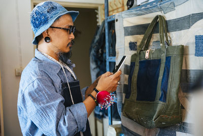 Man working over fabric on table