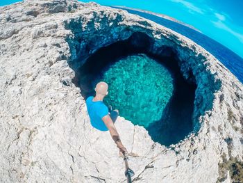 High angle view of man standing on rock