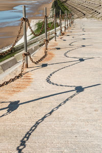 Shadow on sand at shore against sky