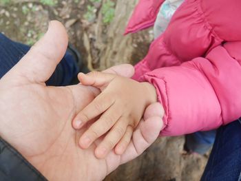 Close-up of hands holding baby hand