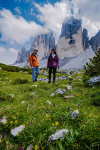 Rear view of people on mountain against sky