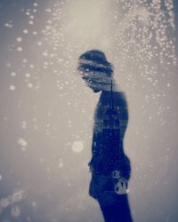 Person holding umbrella standing in snow