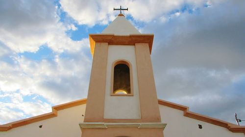 Low angle view of bell tower against sky