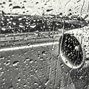 Close-up of wet car windshield during rainy season