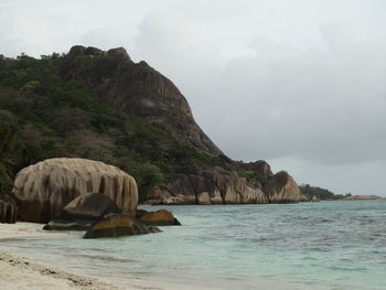 Scenic view of sea and mountain against sky