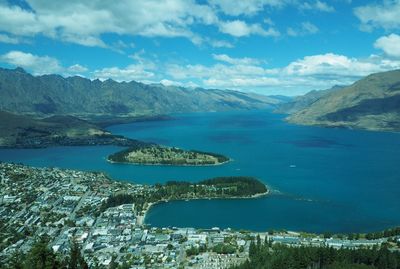 Scenic view of sea and mountains against sky