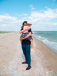 Happy family father daughter hugging marine landscape bearded dad child in hands having fun together
